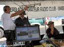 At the W4H special event during the Wings over Homestead Air and Space Show, Robert Cruz, KE4MCL (center), looks on as Steve Taylor, W1HQL (left), aims a satellite antenna and John Kolansinski, KK4QKL (right), makes a contact. [Courtesy of the Everglades ARC]